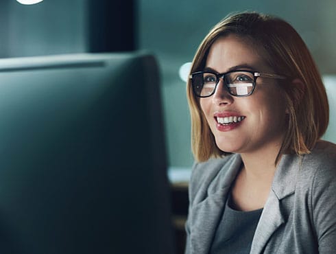 Smiling woman looking at monitor